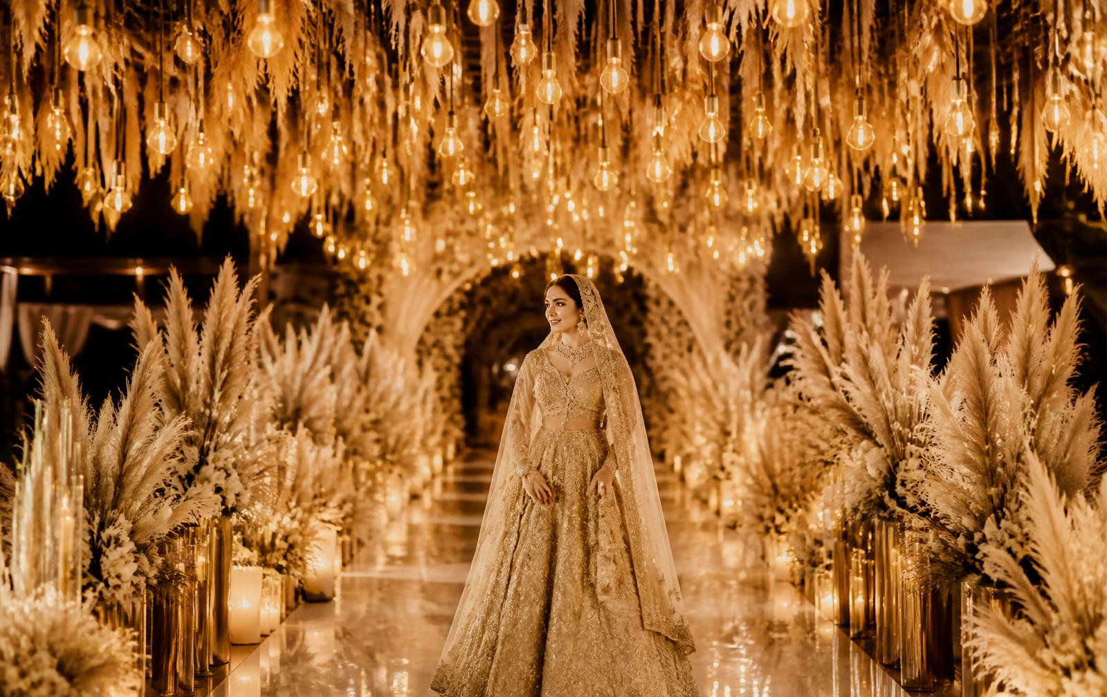 Bride walking beneath a canopy of hanging bulbs